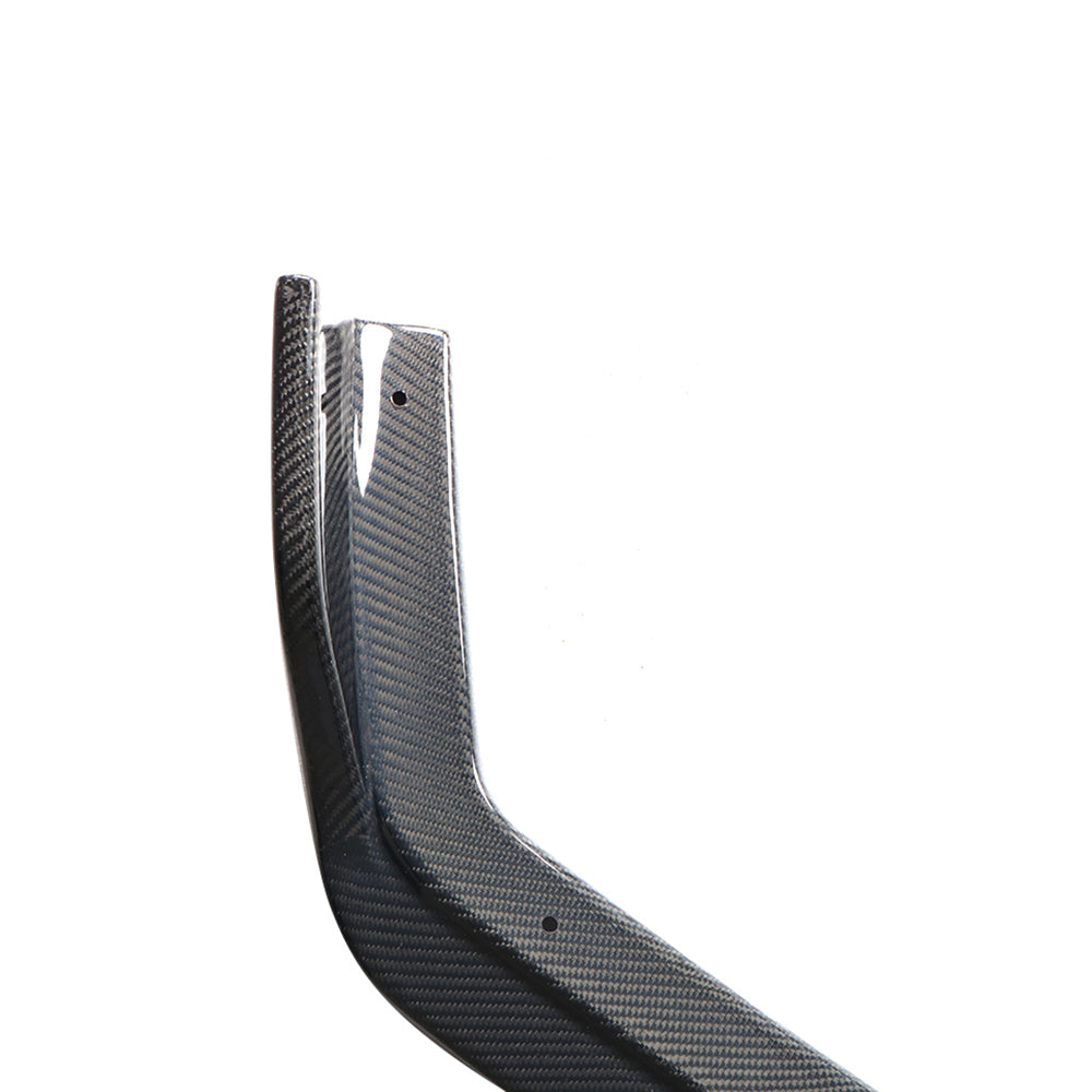 Infiniti Q50 Sport carbon fiber front lip side section close-up showing 3K weave finish and pre-drilled mounting holes