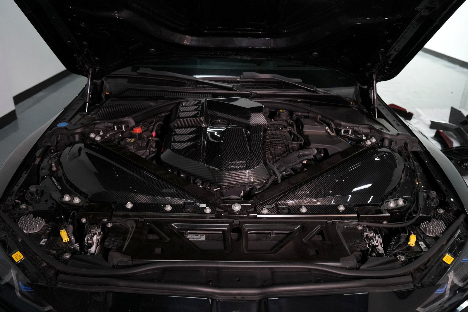 BMW G80 M3 carbon fiber engine cover and engine bay side panels installed