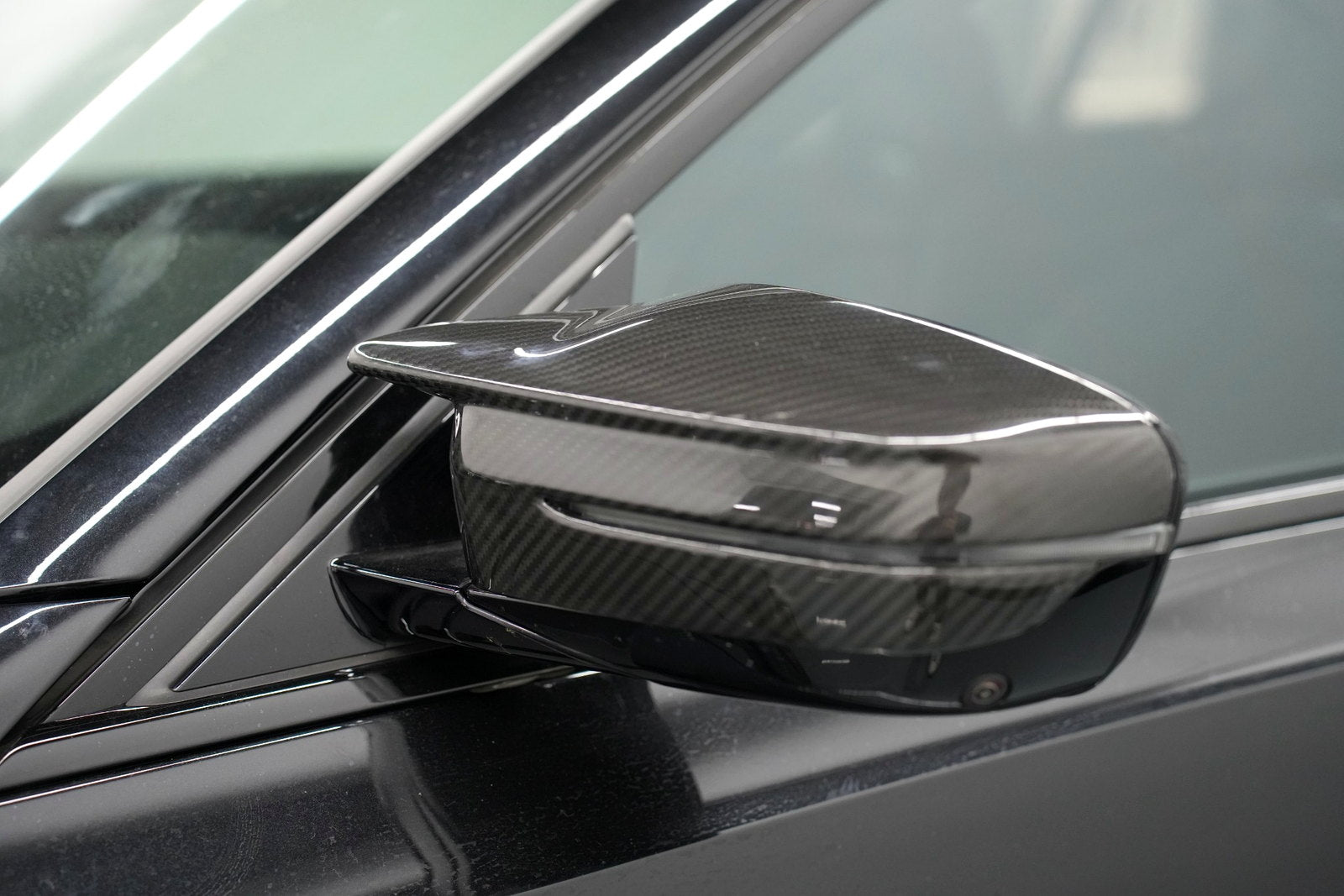 BMW G80 M3 carbon fiber mirror cap installed with camera opening retained